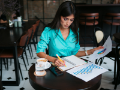 woman working sitting at coffee shop table.