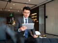Asian businessman on tablet in office