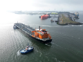 Oil tanker in port, surrounded by water. 