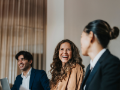 Businesswoman laughing with team