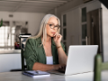 Worried senior woman using laptop