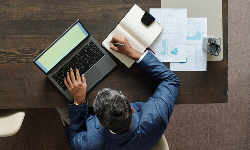 overhead view of advisor reviewing numbers on wealth management platform