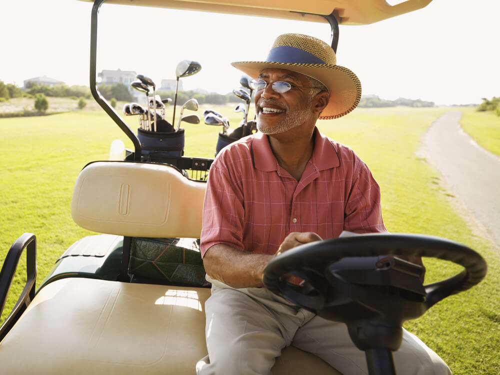 middle-aged man on golf cart considering financial products for his fixed income