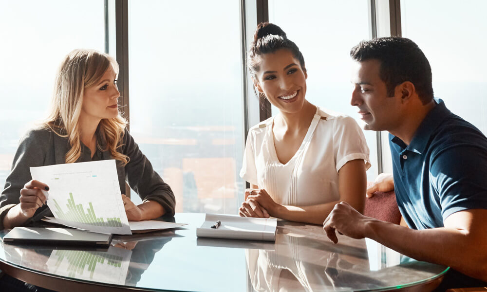 financial advisor talking with clients discussing possible products, hero