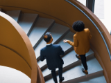 Two institution advisors walking up curved stairs discussing LPL Financial