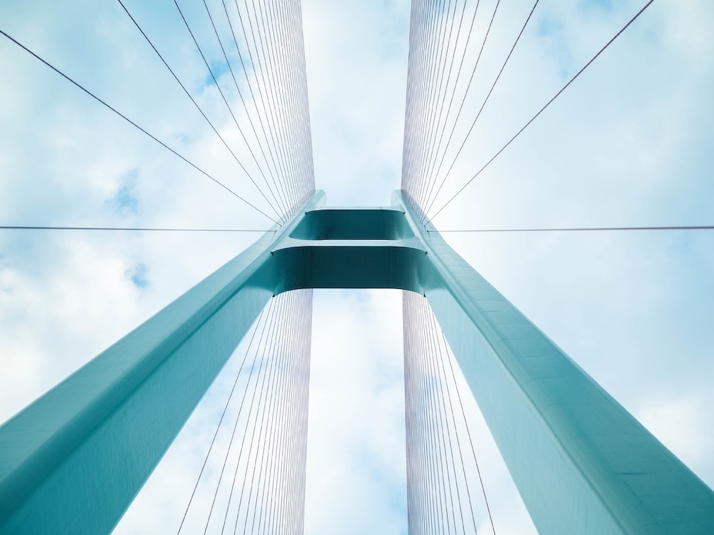 upward perspective of a suspension bridge tower