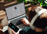 person with headphones, laptop and mobile phone