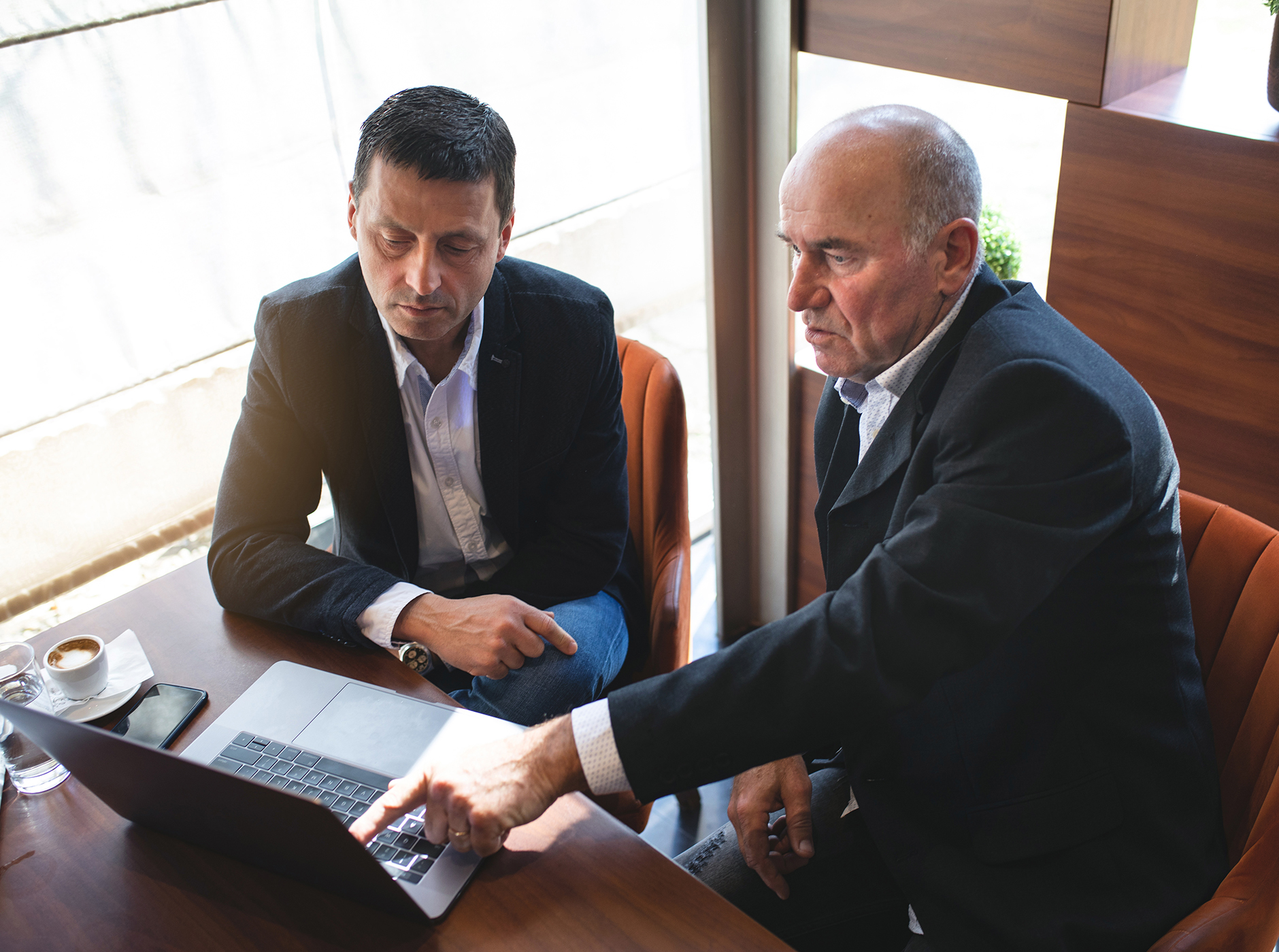 diverse senior business men meeting, working on laptop