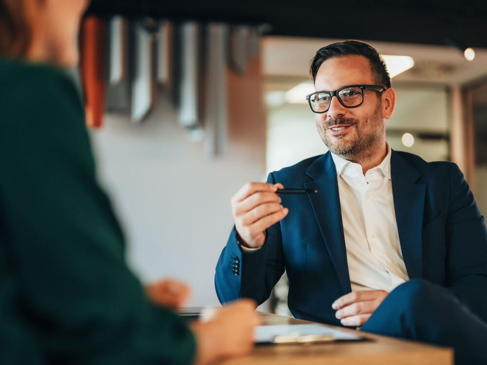 Seated financial advisor discussing Cyan, LPL Financial's AI for Advisors