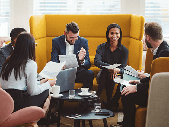 five business people in a meeting