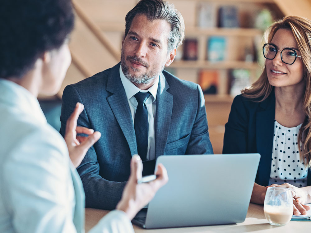 asset manager talking with an affluent couple