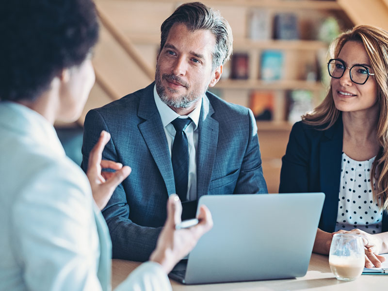 asset manager talking with an affluent couple