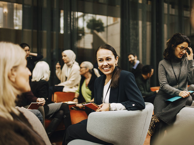 Women advisors meeting in a casual group setting.
