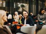 Women advisors meeting in a casual group setting.