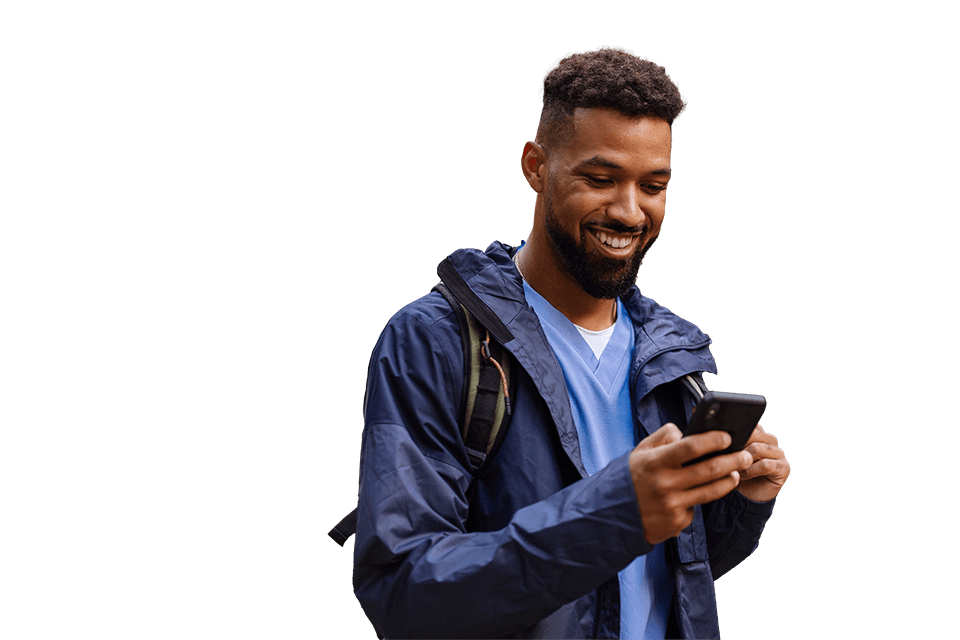 young man with beard, casually dressed in blue shirt and jacket, looking at phone