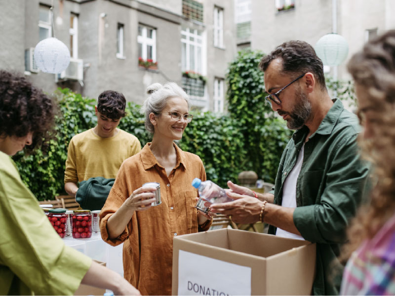 individuals, standing outdoors, engaging with local community