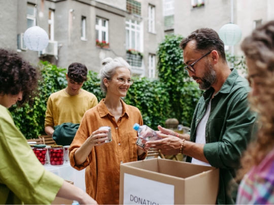 individuals, standing outdoors, engaging with local community