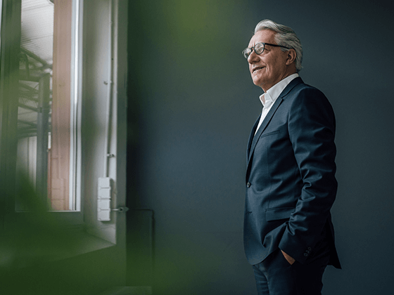 businessman looks outside of window