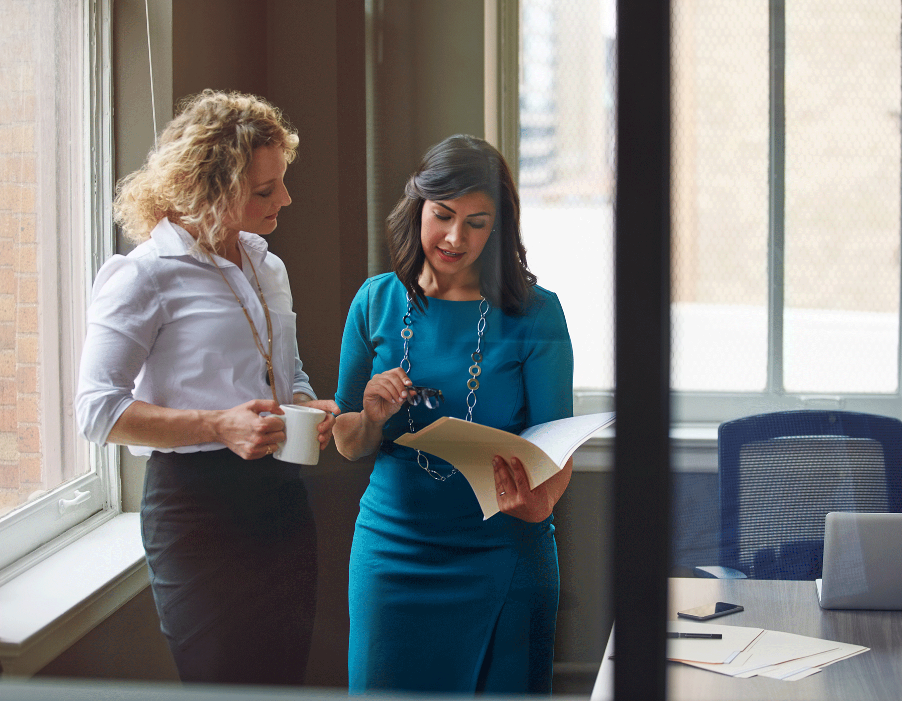 business team members looking at paperwork in office 