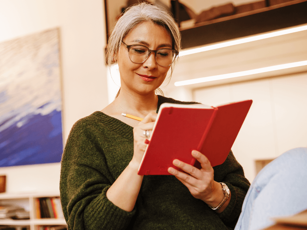illustration, smiling financial investor writing in her journal