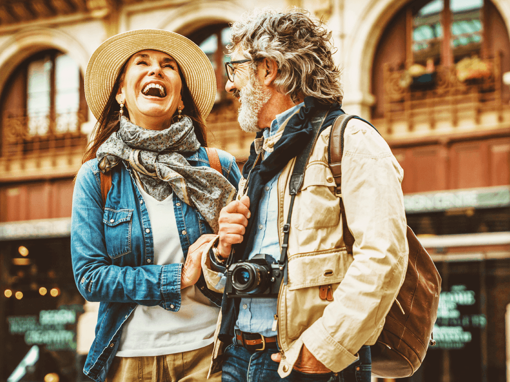 Smiling couple outdoors in a big city.