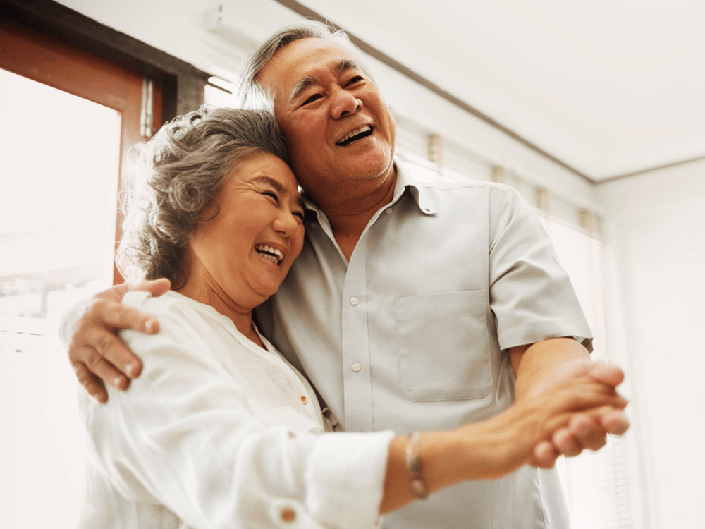 Happy older couple embracing.