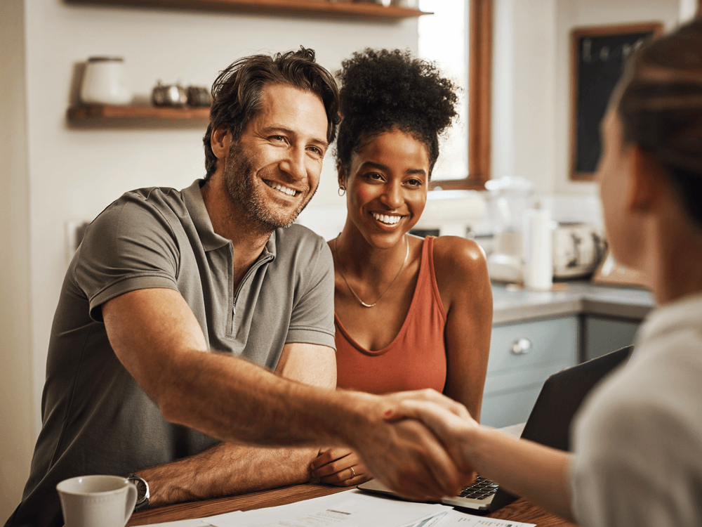 Couple meeting with their financial advisor in their home.