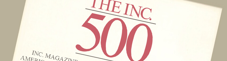 maroon inc magazine 500 logo text on beige paper on brown background