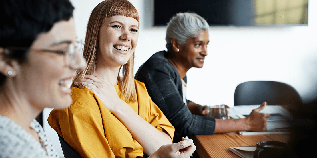 diverse group of women smiling at work image