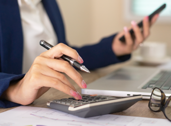 caucasian woman hand typing on calculator