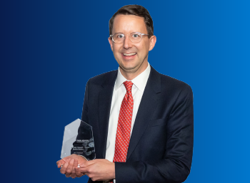 matt morningstar holding the community impact award trophy