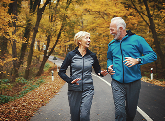 smiling couple jogging on the street in the Fall image