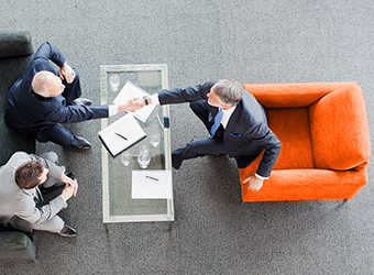 aerial image of 3 seated business men meeting