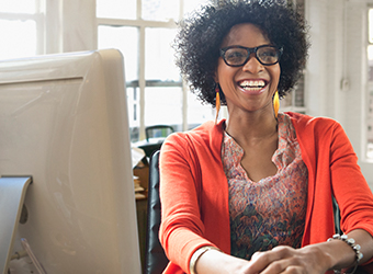 African American woman sitting and smiling in office setting image