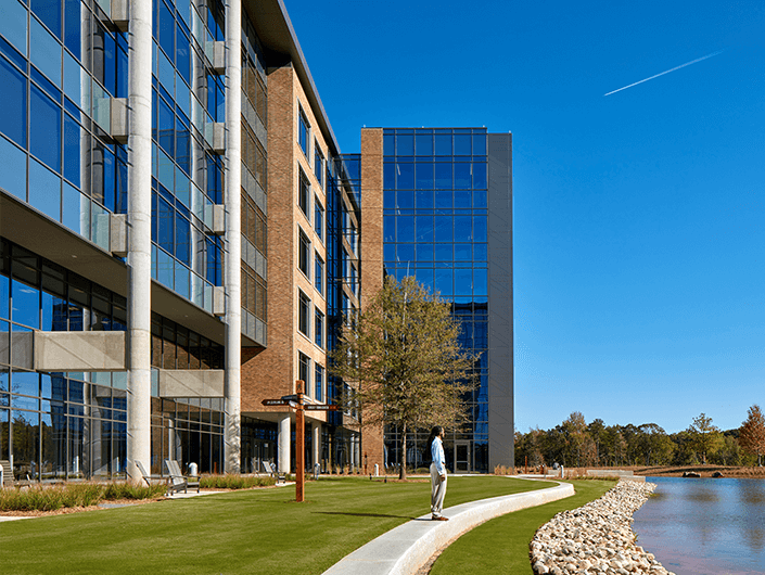back exterior of LPL Financial Fort Mill corporate office with walking path and pond image