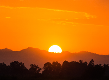 orange sky sunset over mountains and trees image