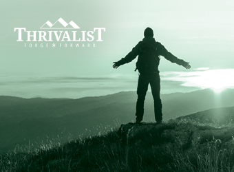LPL Thrivalist image silhouetted person standing at apex of mountain